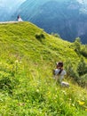 Photographer, high in the mountains conducts a wedding photo session