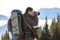 Photographer with hiking backpack taking pictures of nature with digital photo camera Royalty Free Stock Photo