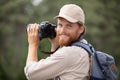 photographer hiking in nature looking at camera