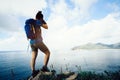 photographer Hiking In Seaside Taking photo With camera