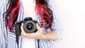 Photographer holding dslr camera. Self portrait, front view. Faceless nice woman with brown red hair in a tshirt with hands Royalty Free Stock Photo