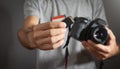 Photographer holding memory card insert DSLR camera Royalty Free Stock Photo
