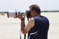 A photographer with a huge lens shooting at the annual Rockford Airfest on June 3, 2012 in Rockford, IL