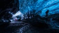 Photographer inside a blue ice cave Royalty Free Stock Photo