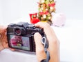 The photographer is intending to use digital camera take pictures of the Christmas decoration, Have a nice holiday on this Royalty Free Stock Photo