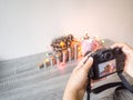 The photographer is intending to use digital camera take pictures of the pink piggy bank and party light Royalty Free Stock Photo