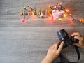 The photographer is intending to use digital camera take pictures of the pink piggy bank and party light Royalty Free Stock Photo