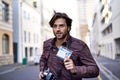 Photographer, journalist and news with man in city for running, press badge and paparazzi. Reporter, story and pictures Royalty Free Stock Photo