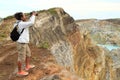 Photographer on Kelimutu taking photos of lakes Tap and Tin Royalty Free Stock Photo