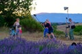 Photographer and lighting assistant taking pictures of a young woman with bicycle