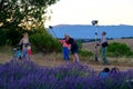 Photographer and lighting assistant taking pictures of a young woman with bicycle