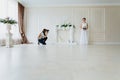 Photographer with long hair is taking pictures the young bride Royalty Free Stock Photo