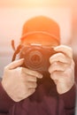 The photographer looks into the camera of the camera holding it in his hands. Soft focus. Photo with filter Royalty Free Stock Photo