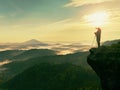 Photographer looks into the landscape and listen the silence. Man prepare camera to takes photos