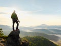 Photographer looks into the landscape and listen the silence. Man prepare camera to takes photos Royalty Free Stock Photo