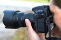 Photographer looks in the viewfinder of the camera closeup