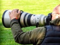 Photographer making a shot with large lens