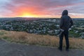 Photographer man wearing hoody watching sunrise over Auckland ci Royalty Free Stock Photo