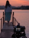 A beautiful sunset, young woman while shooting with beautiful blurred background