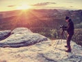 Photographer on mountain cliff take picture of landscape awaking Royalty Free Stock Photo