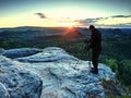 Photographer on mountain cliff take picture of landscape awaking Royalty Free Stock Photo