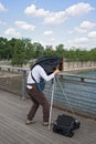 Photographer with old plate camera on the seine bridge Passerelle Solferino in Paris Royalty Free Stock Photo