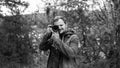 Photographer photographing in autumn forest. Travel and hobbie concept. day