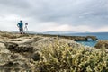 Photographer photographs seascape on the coast of Crete