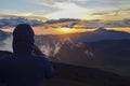Photographer picturing sunset in the mountain