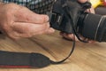 Photographer placing an sd memory card in a professional still camera Royalty Free Stock Photo