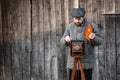 Photographer prepares for shooting and inserts film holder into retro large format camera. Concept - photography of the 1930s- Royalty Free Stock Photo