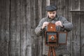 Photographer prepares for shooting and inserts film holder into retro large format camera. Concept - photography of the 1930s- Royalty Free Stock Photo