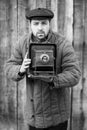 Photographer prepares for shooting on large format camera. Concept - photography of the 1930s-1950s Royalty Free Stock Photo