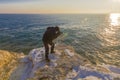 Photographer on the rocks taking landscape pictures Royalty Free Stock Photo