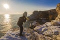 Photographer on the rocks taking landscape pictures Royalty Free Stock Photo