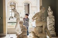 Photographer in Roman sculpture gallery, Louvre, Paris