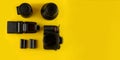 Photographer`s equipment.Flat lay composition with photographer`s equipment and accessories on yellow background