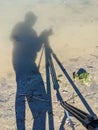 Photographer\'s Silhouette: Camera, Tripod & Person in Muddy Pond