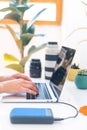 Photographer`s workplace, laptop and camera lenses on a white table, hands on keyboard close up Royalty Free Stock Photo