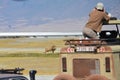 Photographer on safari taking pictures of a male lion.