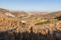 Photographer shadow with Small mountains, valley and typical vegetation in Milos