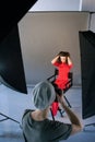 Photographer shoot model in red at studio session Royalty Free Stock Photo