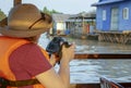 Photographer shooting floating fishing village of Tonle Sap River in Cambodia
