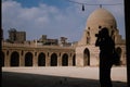 Photographer shooting inside the Mosque of Ibn Tulun, Cairo, Egypt with blue sky Royalty Free Stock Photo