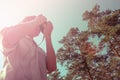 Photographer shoots on camera in forest, bottom view