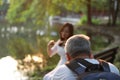Photographer is taking a picture of a female model play violin over sunset sunrise by river in a park garden forest outdoor nature Royalty Free Stock Photo