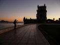 Photographer silhouette at sunset near Belem tower, famous tourist attraction in Lisbon, Portugal Royalty Free Stock Photo