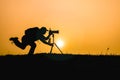 Photographer silhouette sunset time photo shoot in nature Royalty Free Stock Photo