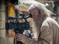 Photographer with silver hair and long beard