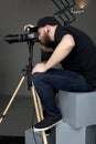 Photographer sits on cubes and photographed